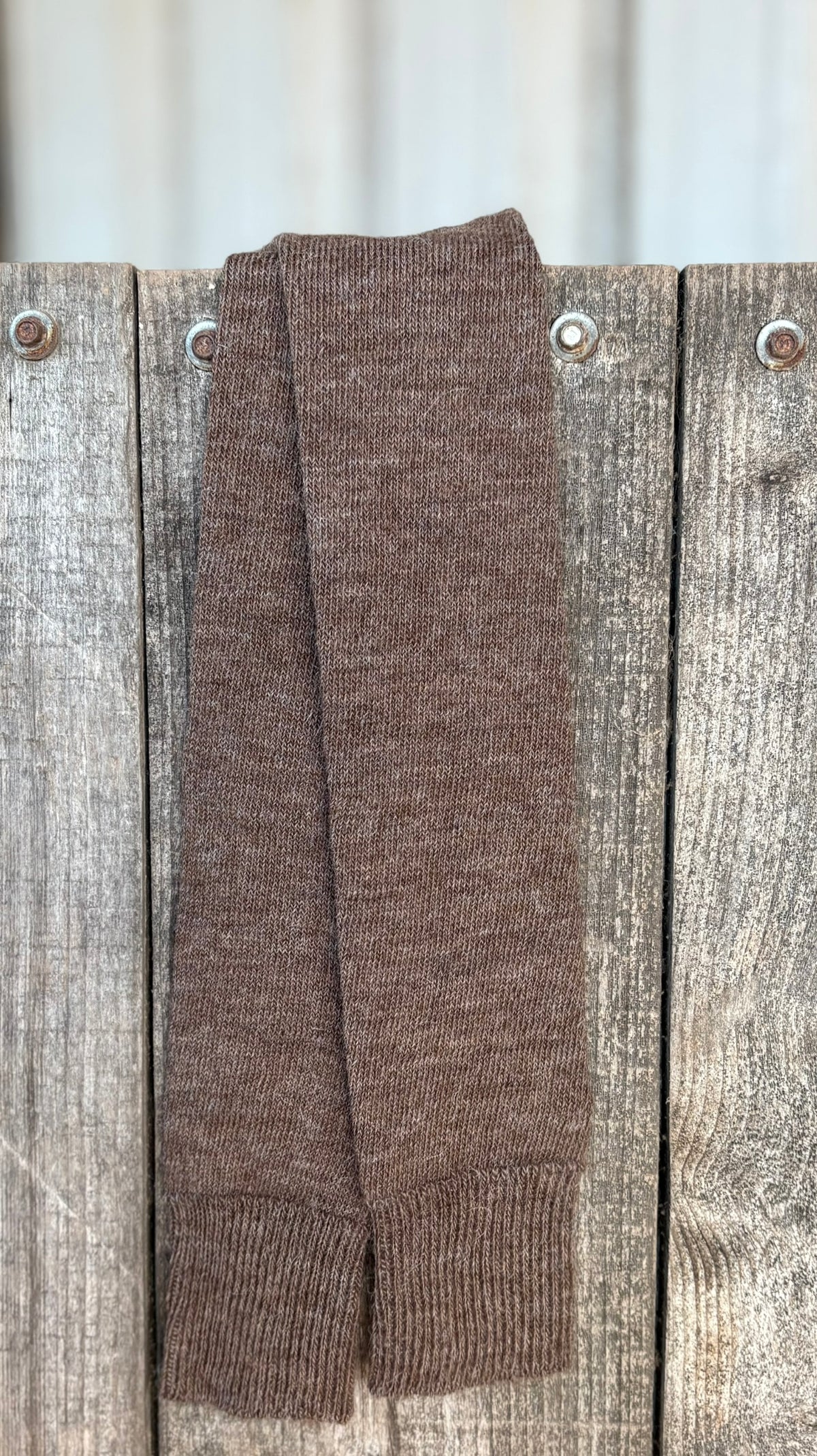 Brown long activity alpaca socks on wooden background