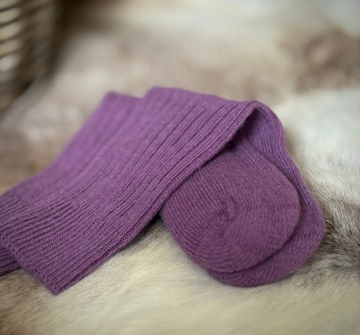 Damson alpaca short ribbed socks on a fur surface