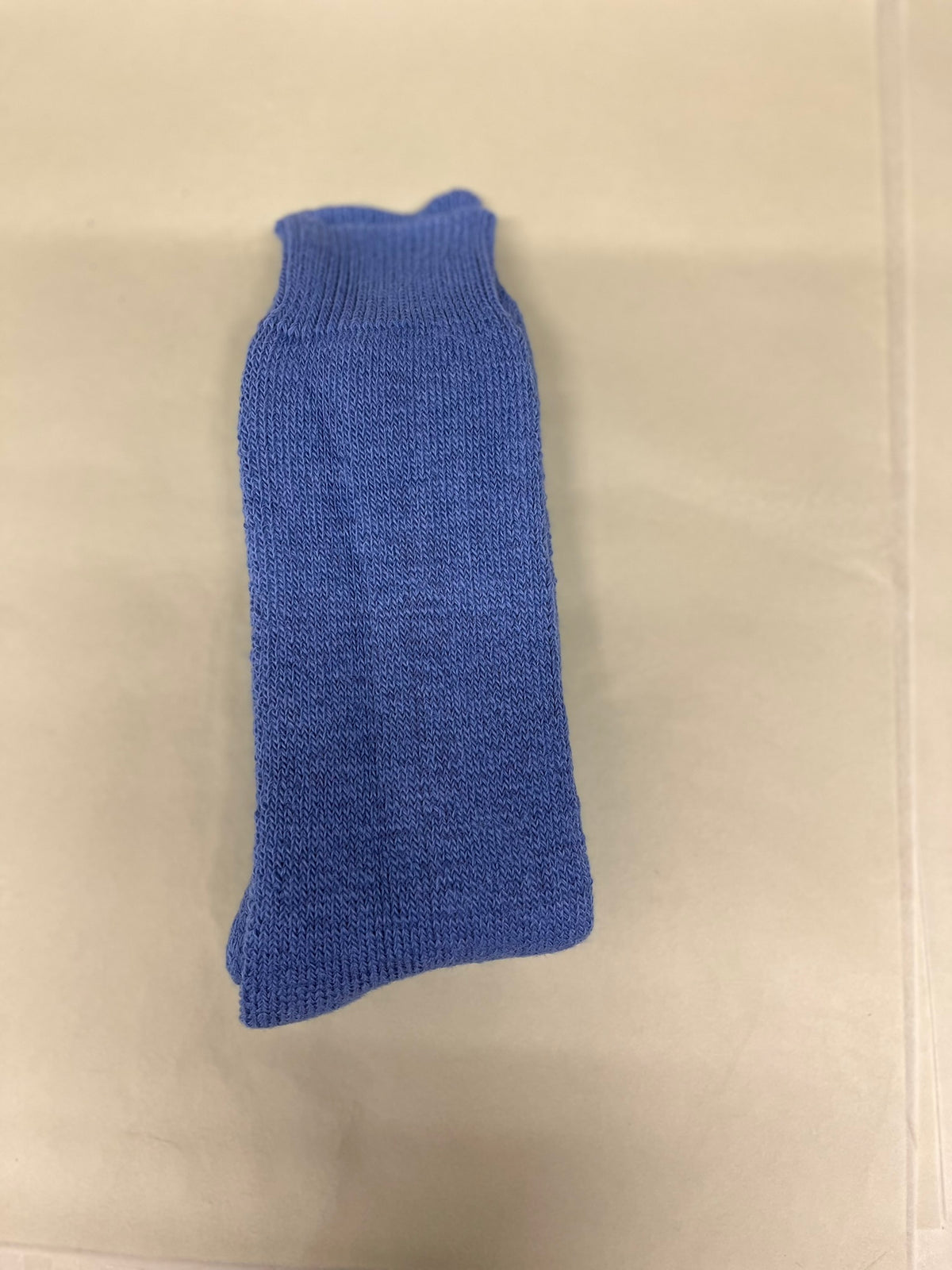 Mid Blue walking alpaca socks pale green background
