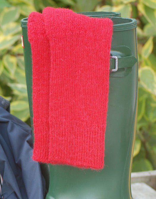 Burnt Orange short ribbed alpaca socks draped over wellies