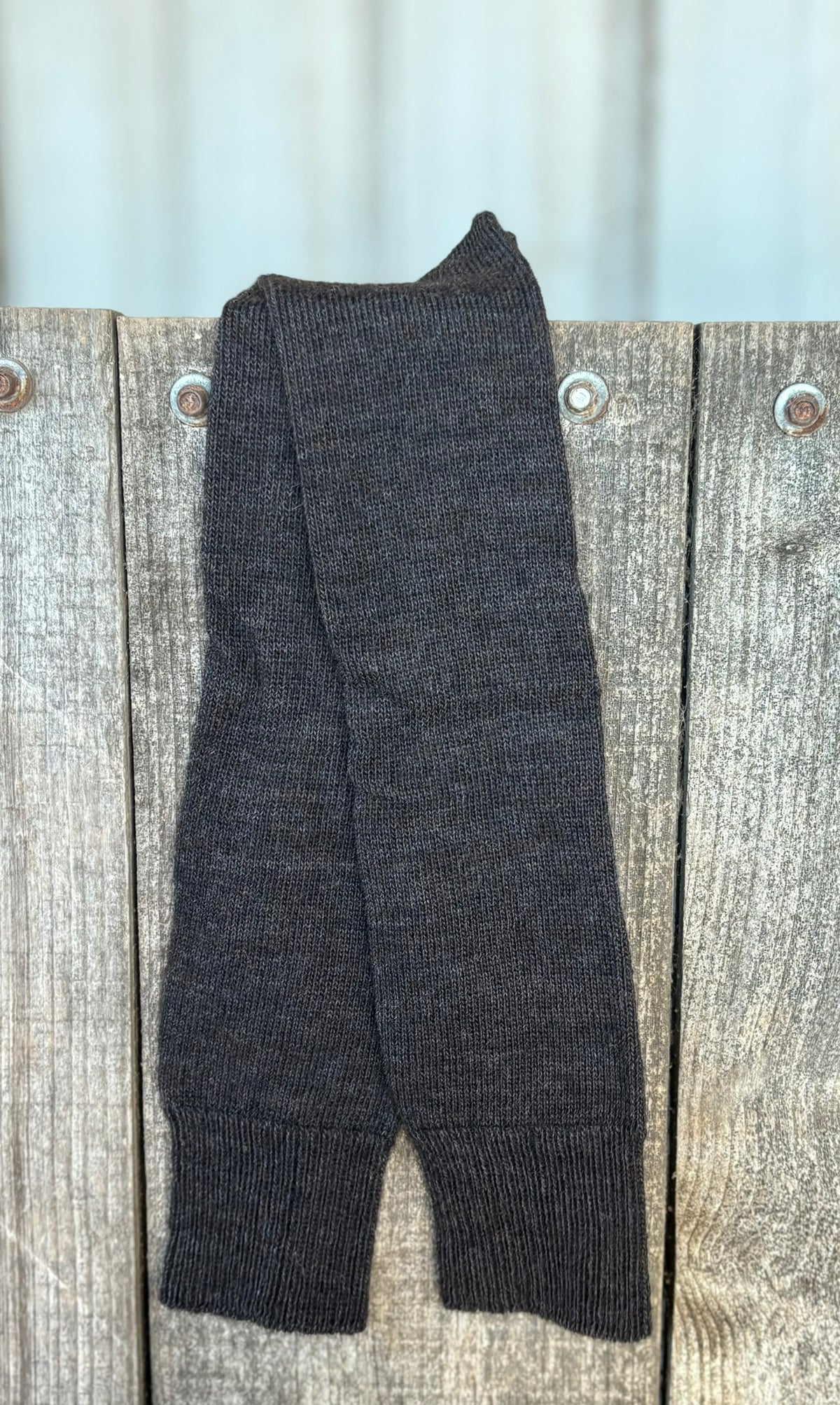 Charcoal Long Activity alpaca socks on a wooden surface