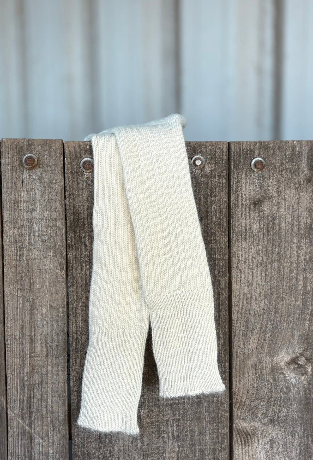 cream three quarter alpaca socks on wooden gate