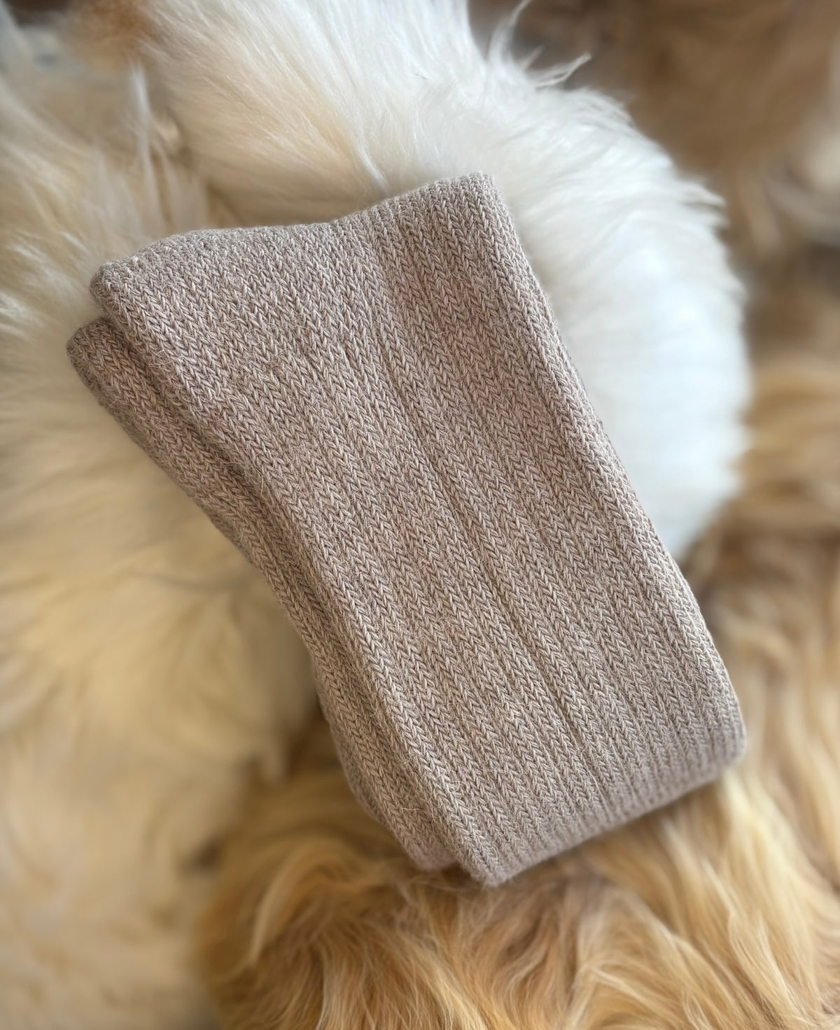 fawn short ribbed alpaca socks on a fluffy white surface