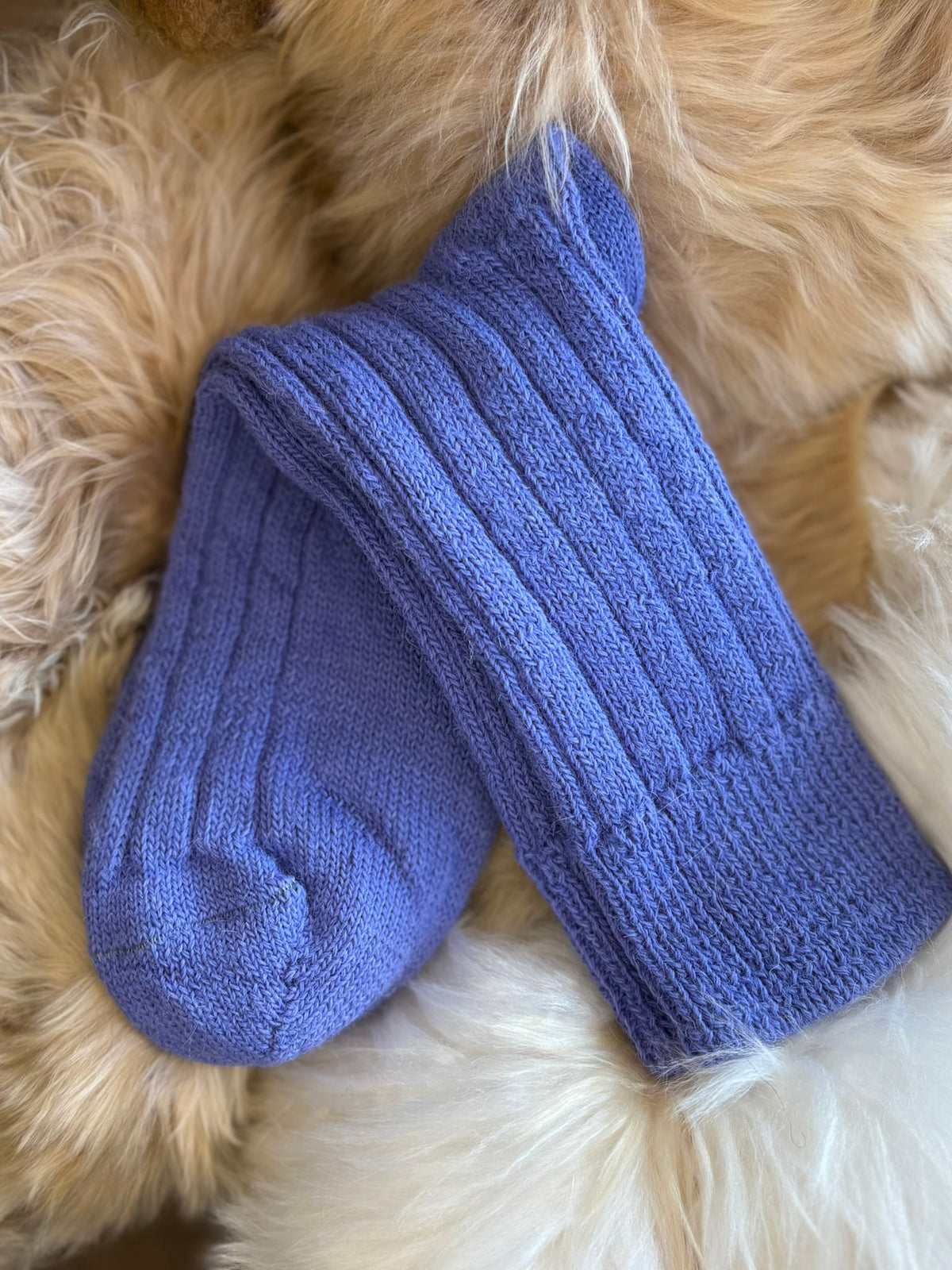 mid blue alpaca bed socks fluffy background