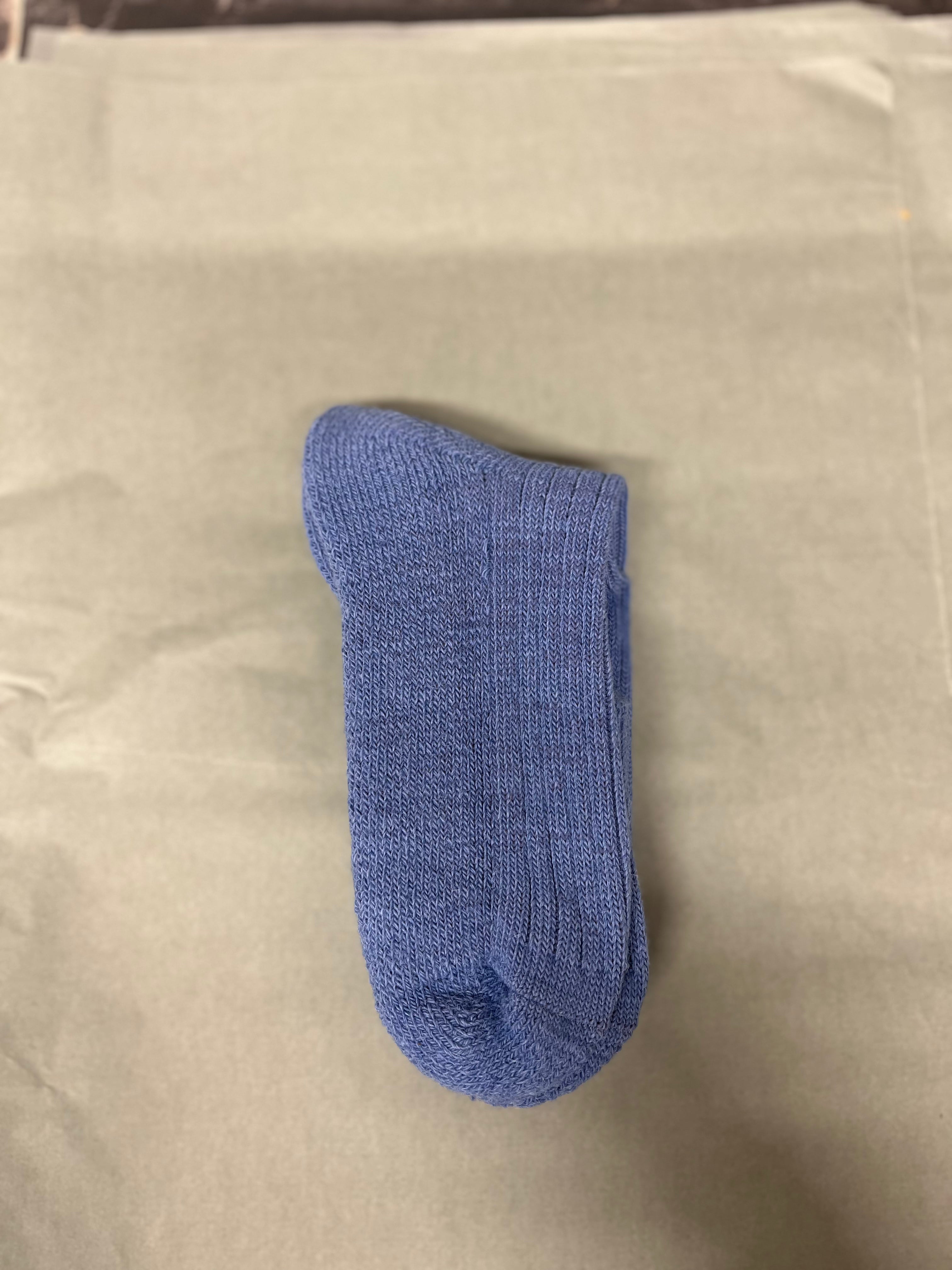 mid blue three quarter alpaca sock pale green background