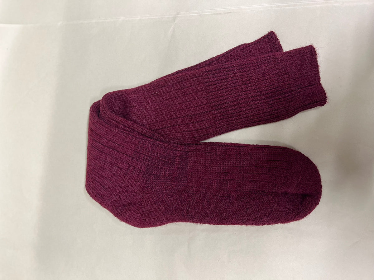 Pair of mulberry three quarter alpaca socks on a light green background