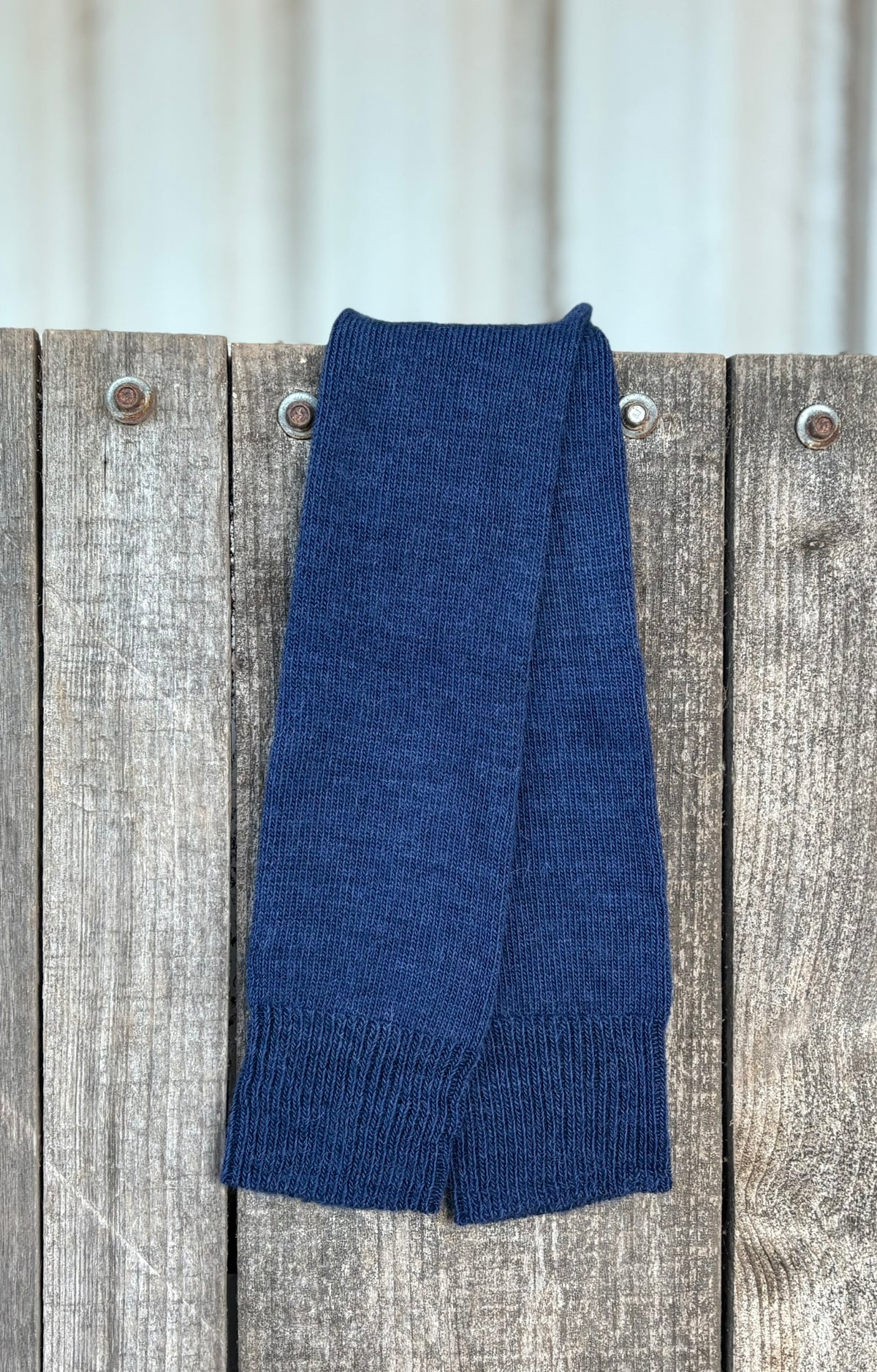 Navy knee length everyday alpaca socks  on a wooden surface