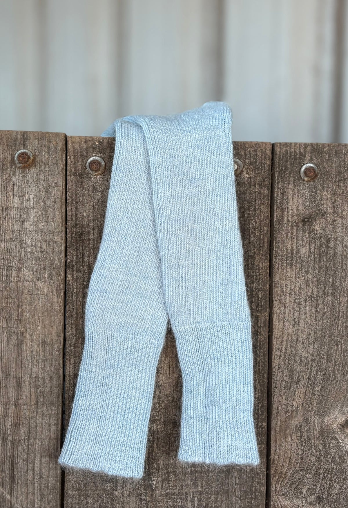 pale blue three quarter alpaca socks on wooden gate