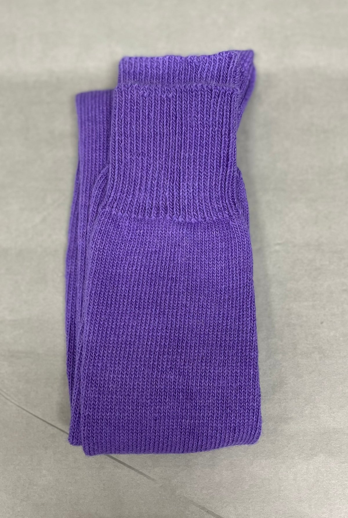 purple walking alpaca sock pale green background